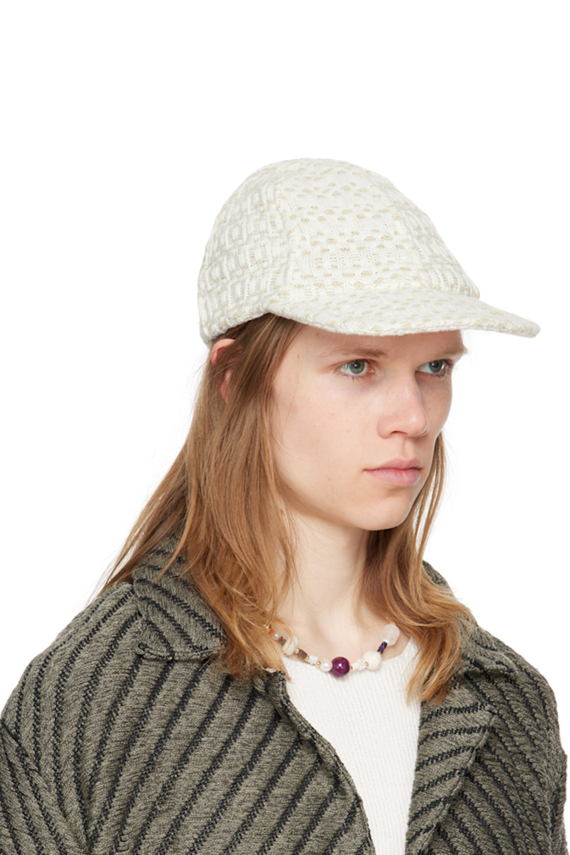 Handcrafted knit cotton cap in off-white.

· Jacquard check pattern throughout
· Flat brim
· Elasticized trim at back face
· Unlined

Supplier color: Chalk