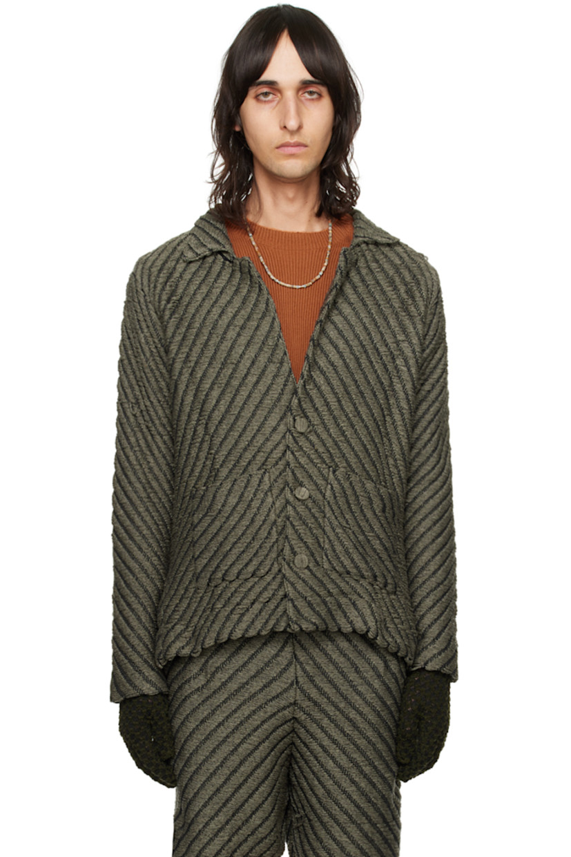 Hand-knit rayon jacket. Laddering and chevron pattern throughout.

· Notched lapel
· Button closure
· Patch pockets
· Vented outseams
· Dropped shoulders
· Logo flag at back hem

Available exclusively at SSENSE.

Supplier color: Smoke