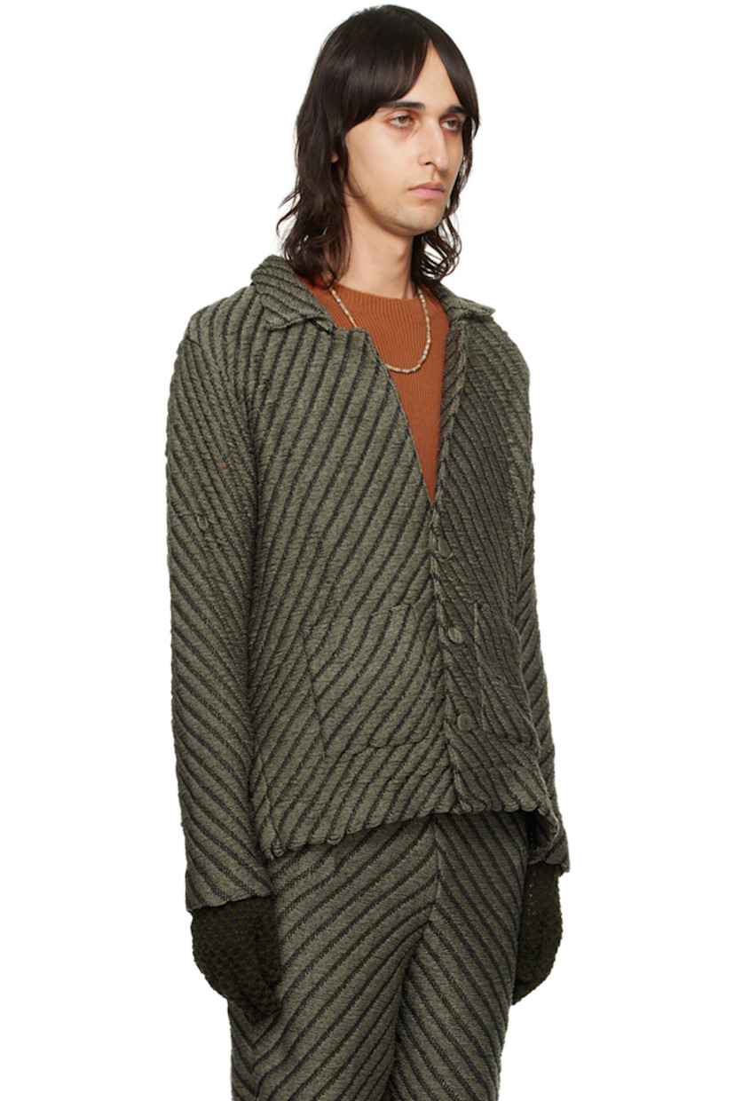 Hand-knit rayon jacket. Laddering and chevron pattern throughout.

· Notched lapel
· Button closure
· Patch pockets
· Vented outseams
· Dropped shoulders
· Logo flag at back hem

Available exclusively at SSENSE.

Supplier color: Smoke