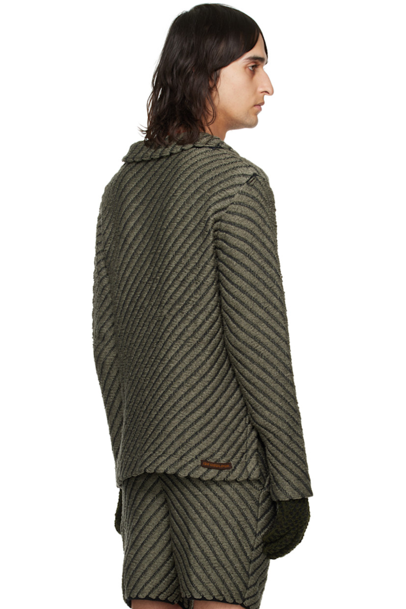 Hand-knit rayon jacket. Laddering and chevron pattern throughout.

· Notched lapel
· Button closure
· Patch pockets
· Vented outseams
· Dropped shoulders
· Logo flag at back hem

Available exclusively at SSENSE.

Supplier color: Smoke