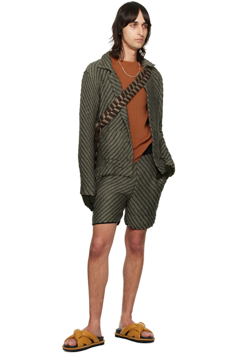 Hand-knit rayon jacket. Laddering and chevron pattern throughout.

· Notched lapel
· Button closure
· Patch pockets
· Vented outseams
· Dropped shoulders
· Logo flag at back hem

Available exclusively at SSENSE.

Supplier color: Smoke