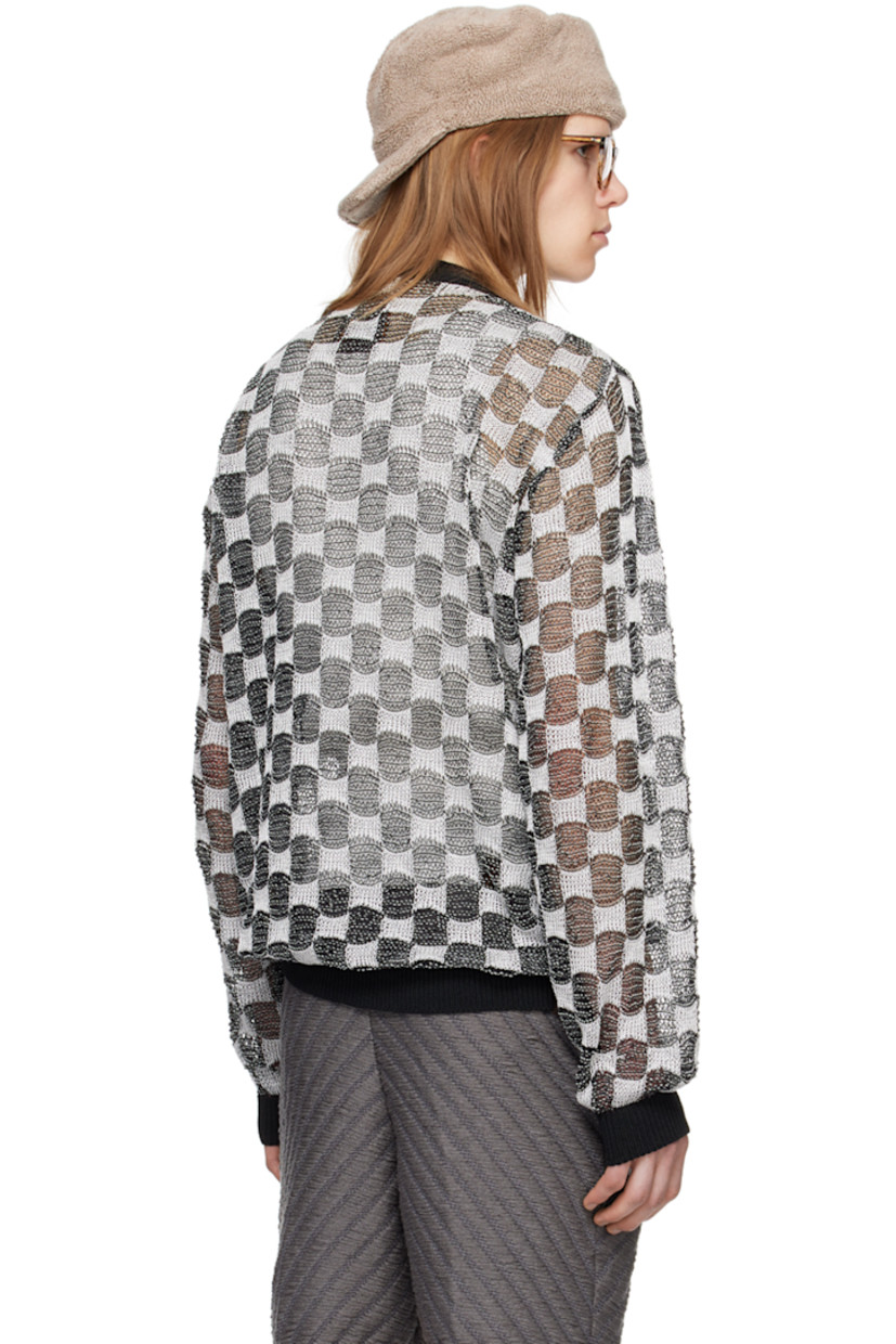 Open knit rayon sweater. Jacquard check pattern throughout.

· Rib knit crewneck, hem, and cuffs
· Dropped shoulders
· Logo flag at back hem

Available exclusively at SSENSE.

Supplier color: BNW
