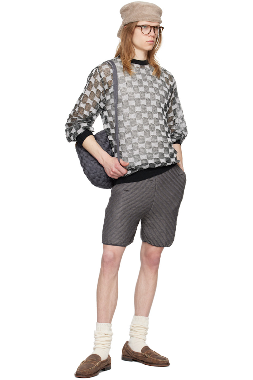 Open knit rayon sweater. Jacquard check pattern throughout.

· Rib knit crewneck, hem, and cuffs
· Dropped shoulders
· Logo flag at back hem

Available exclusively at SSENSE.

Supplier color: BNW