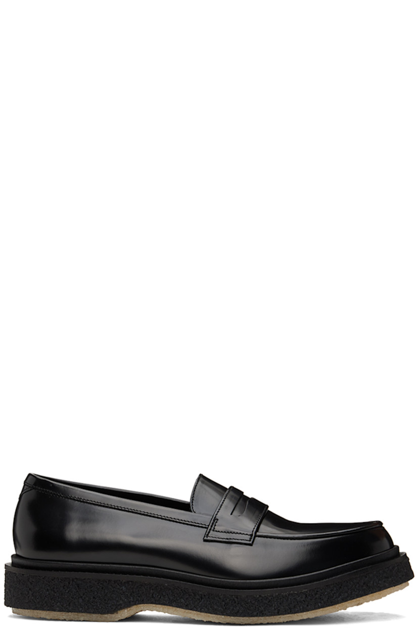 Polished leather loafers in black.

· Moc toe
· Strap with cutout at vamp
· Logo printed at padded leather footbed
· Suede and buffed leather lining 
· Scalloped detailing at welt
· Crepe rubber sole
· Heel: H1.25"

Supplier color: Black