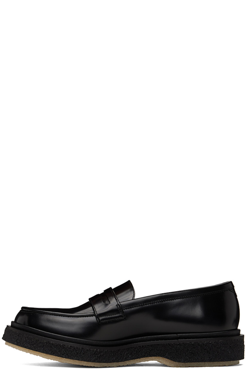 Polished leather loafers in black.

· Moc toe
· Strap with cutout at vamp
· Logo printed at padded leather footbed
· Suede and buffed leather lining 
· Scalloped detailing at welt
· Crepe rubber sole
· Heel: H1.25"

Supplier color: Black