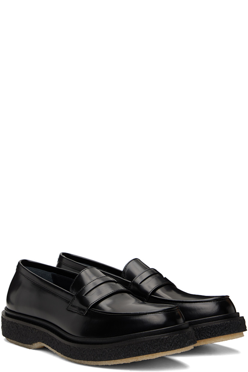 Polished leather loafers in black.

· Moc toe
· Strap with cutout at vamp
· Logo printed at padded leather footbed
· Suede and buffed leather lining 
· Scalloped detailing at welt
· Crepe rubber sole
· Heel: H1.25"

Supplier color: Black