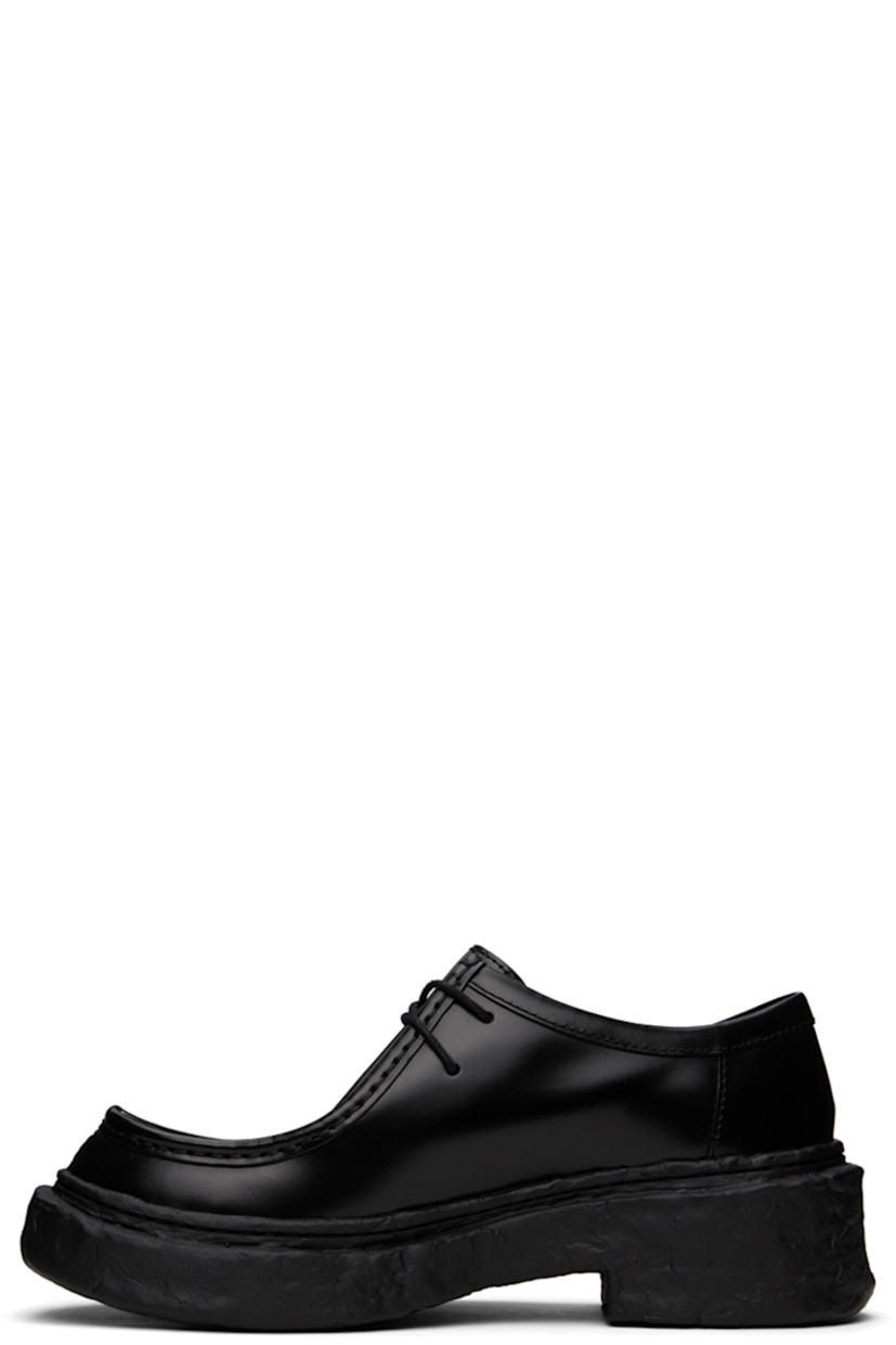 Polished calfskin derbys in black.

· Moc toe
· Lace-up closure
· Cushioned OrthoLite® Recycled™ footbed
· Suede and buffed leather lining
· Sculptural treaded PU sole

Supplier color: Black