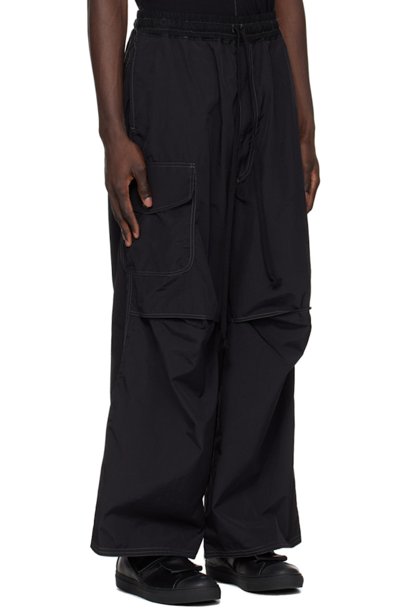 Handcrafted stretch nylon faille trousers. Loose thread detailing throughout. 

· Drawstring at elasticized waistband
· Four-pocket styling
· Zip-fly
· Darts and tucks at knees
· Partial cotton twill lining
· Contrast stitching in gray

Supplier color: Black