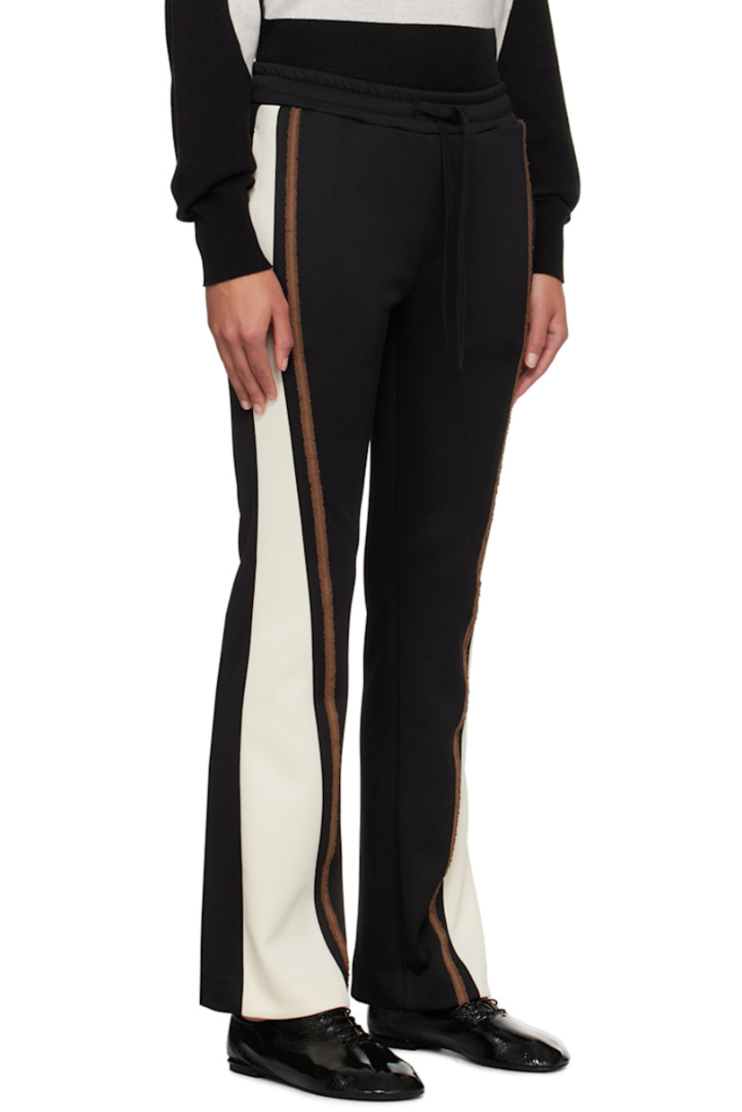 Flared stretch polyester-blend jersey track pants.

· Paneled construction
· Drawstring at elasticized waistband
· Four-pocket styling
· Frayed trim at outseams
· Logo embroidered at back pocket

Supplier color: Black/Cream