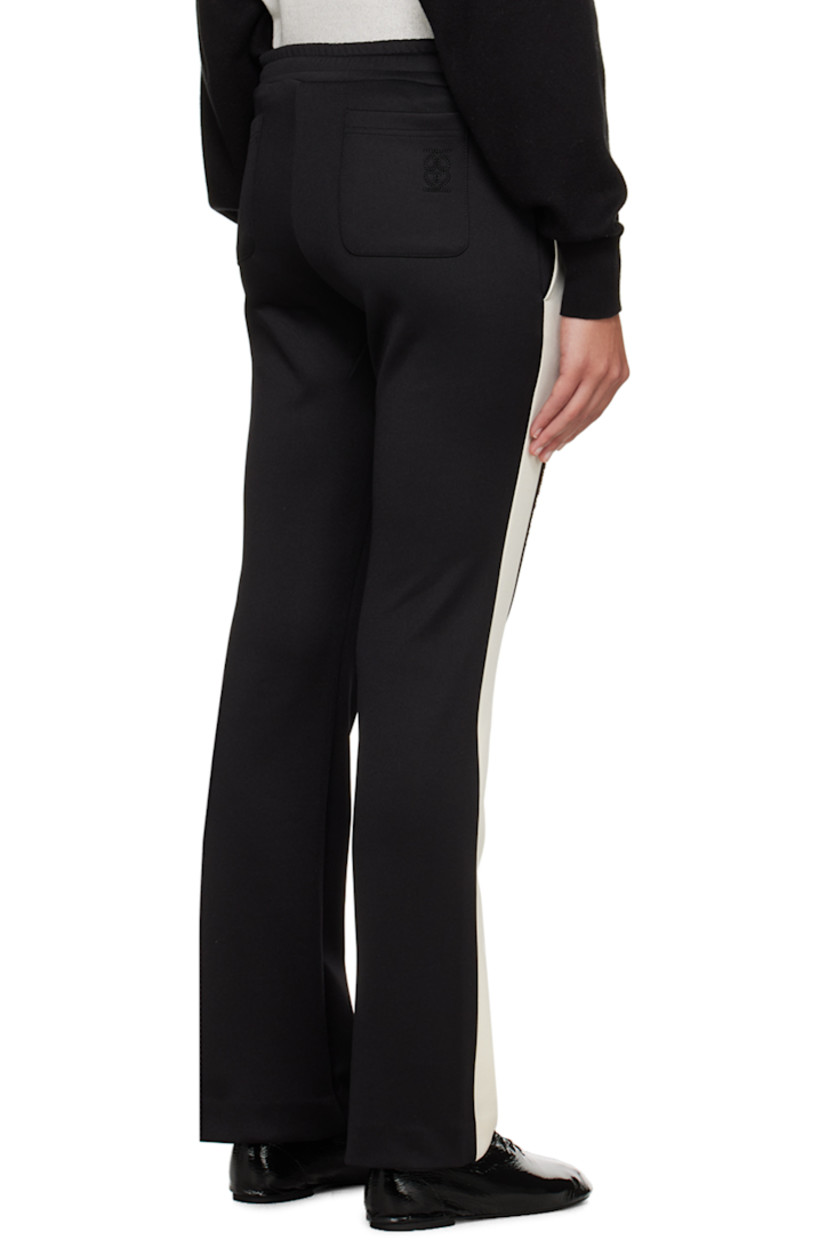 Flared stretch polyester-blend jersey track pants.

· Paneled construction
· Drawstring at elasticized waistband
· Four-pocket styling
· Frayed trim at outseams
· Logo embroidered at back pocket

Supplier color: Black/Cream