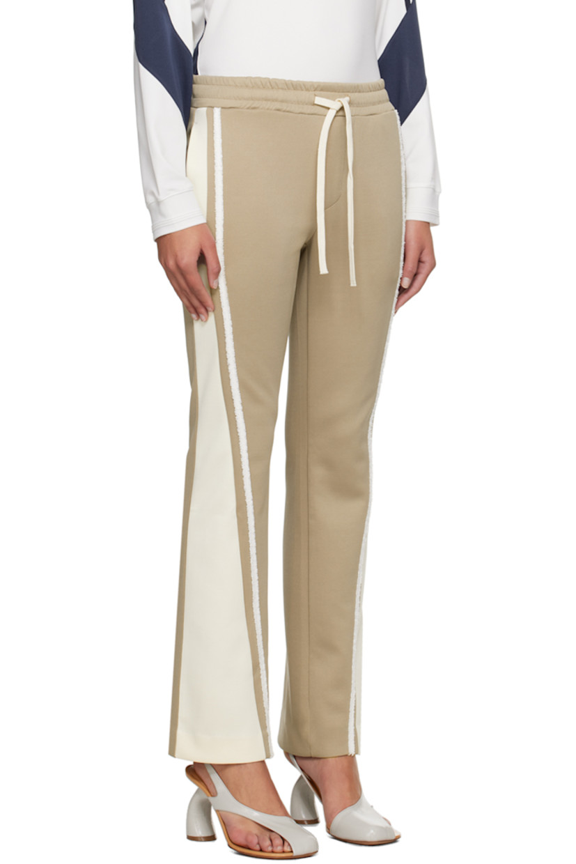 Flared stretch polyester-blend jersey track pants.

· Paneled construction
· Drawstring at elasticized waistband
· Four-pocket styling
· Frayed trim at outseams
· Logo embroidered at back pocket

Supplier color: Beige/Cream