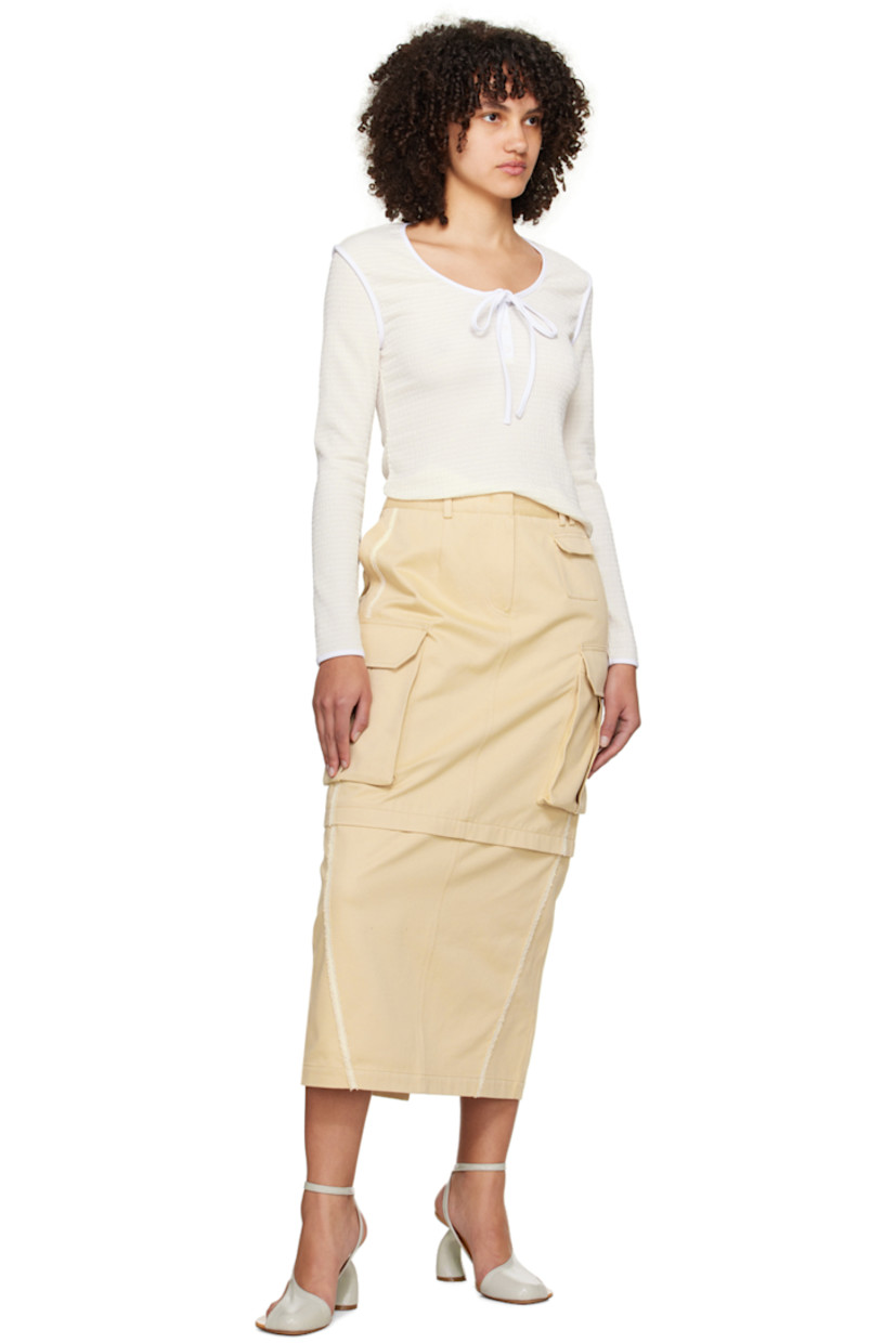 Crinkled polyester jersey T-shirt. Stretch polyester jersey trim throughout.

· Self-tie straps at scoop neck
· Three-button placket
· Logo embroidered at back collar

Supplier color: Cream