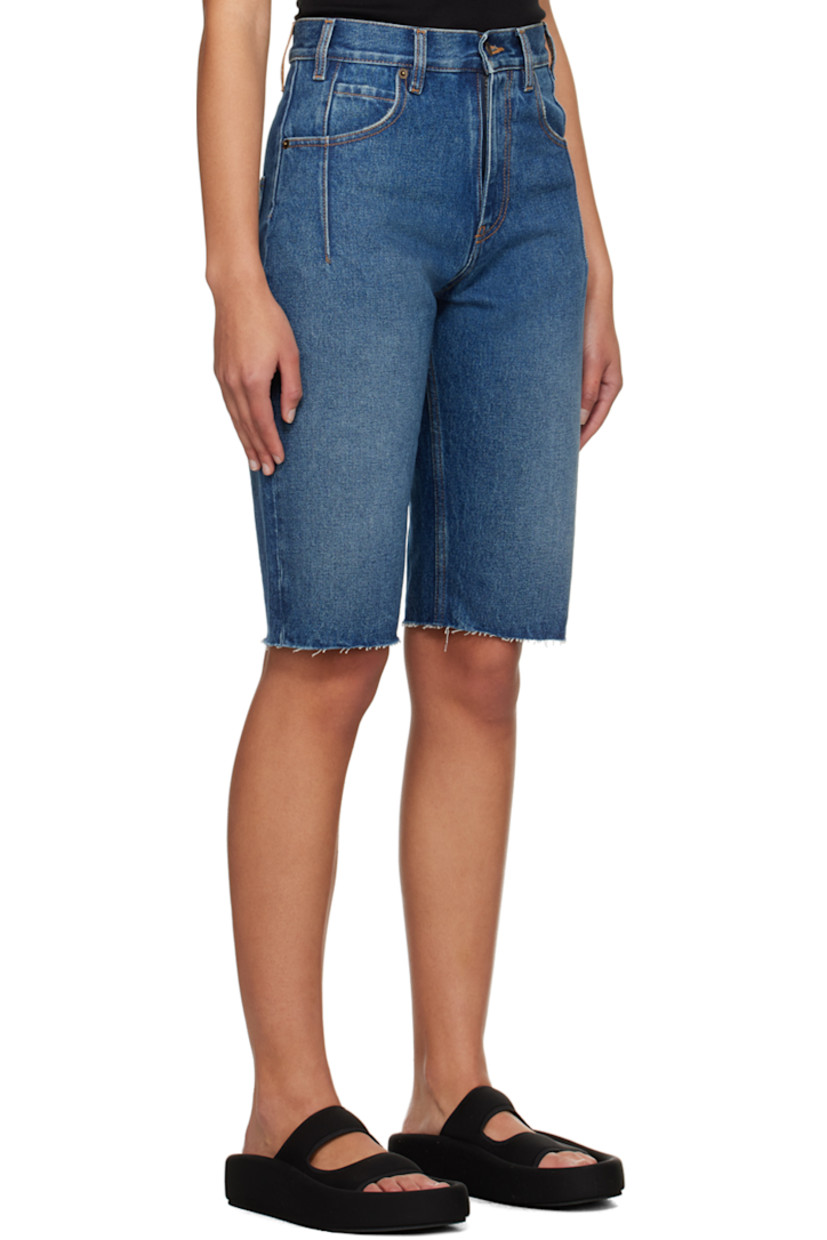 Non-stretch denim shorts. Darts, fading, and subtle distressing throughout.

· Belt loops
· Five-pocket styling
· Zip-fly
· Raw edge at cuffs
· Logo patch at back waistband
· Contrast stitching in tan

Supplier color: Medium wash