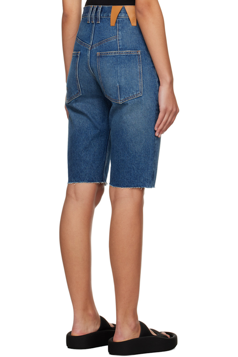 Non-stretch denim shorts. Darts, fading, and subtle distressing throughout.

· Belt loops
· Five-pocket styling
· Zip-fly
· Raw edge at cuffs
· Logo patch at back waistband
· Contrast stitching in tan

Supplier color: Medium wash