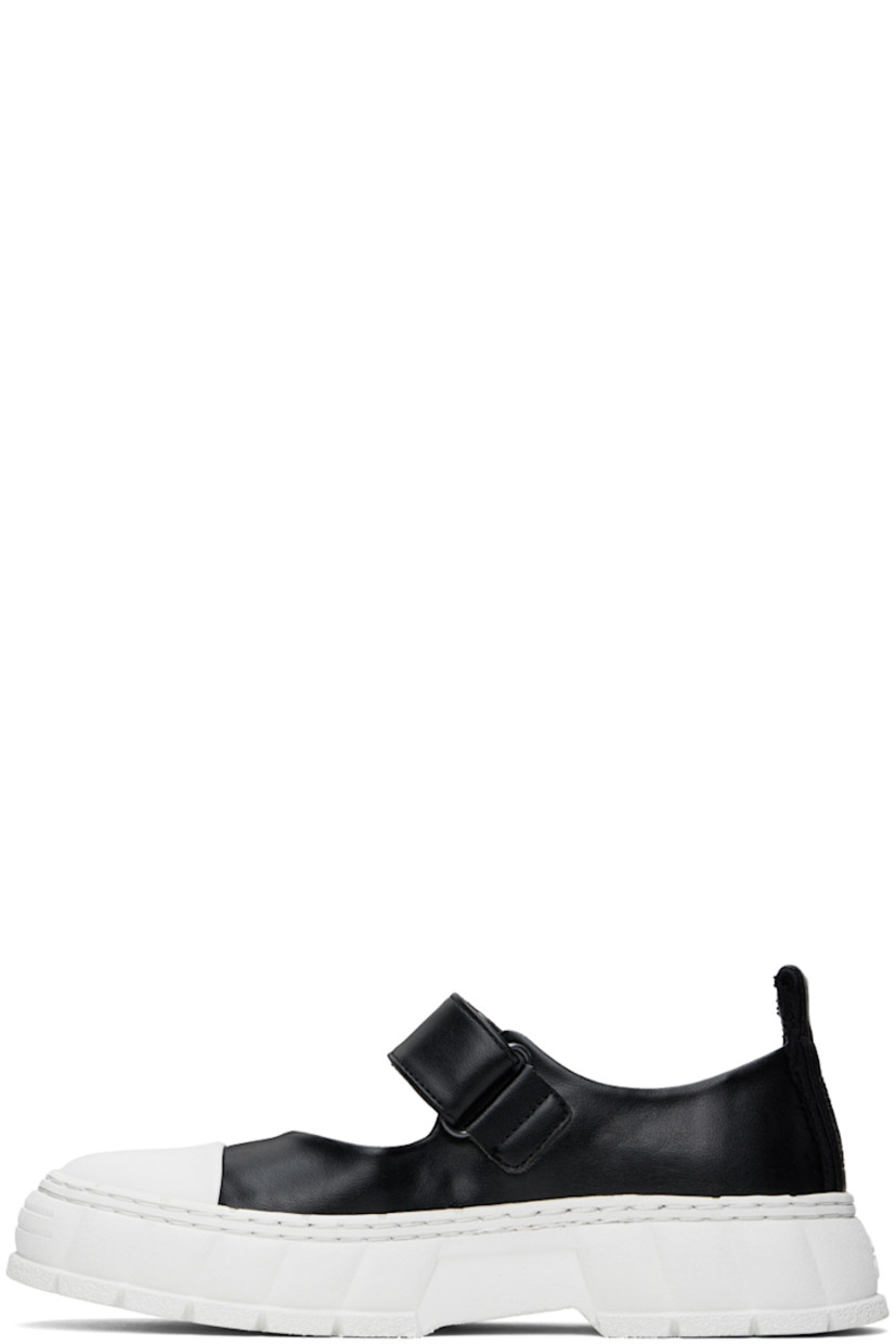 Handcrafted low-top PETA-certified buffed AppleSkin™️ faux-leather Mary Jane-style sneakers in black.

· Rubber cap toe
· Velcro strap at vamp
· Canvas trim and pull-loop at heel tab
· Logo embossed at heel counter
· Logo printed at padded footbed 
· Grained faux-leather lining
· Textured rubber platform midsole
· Treaded recycled rubber sole

Supplier color: Black apple
