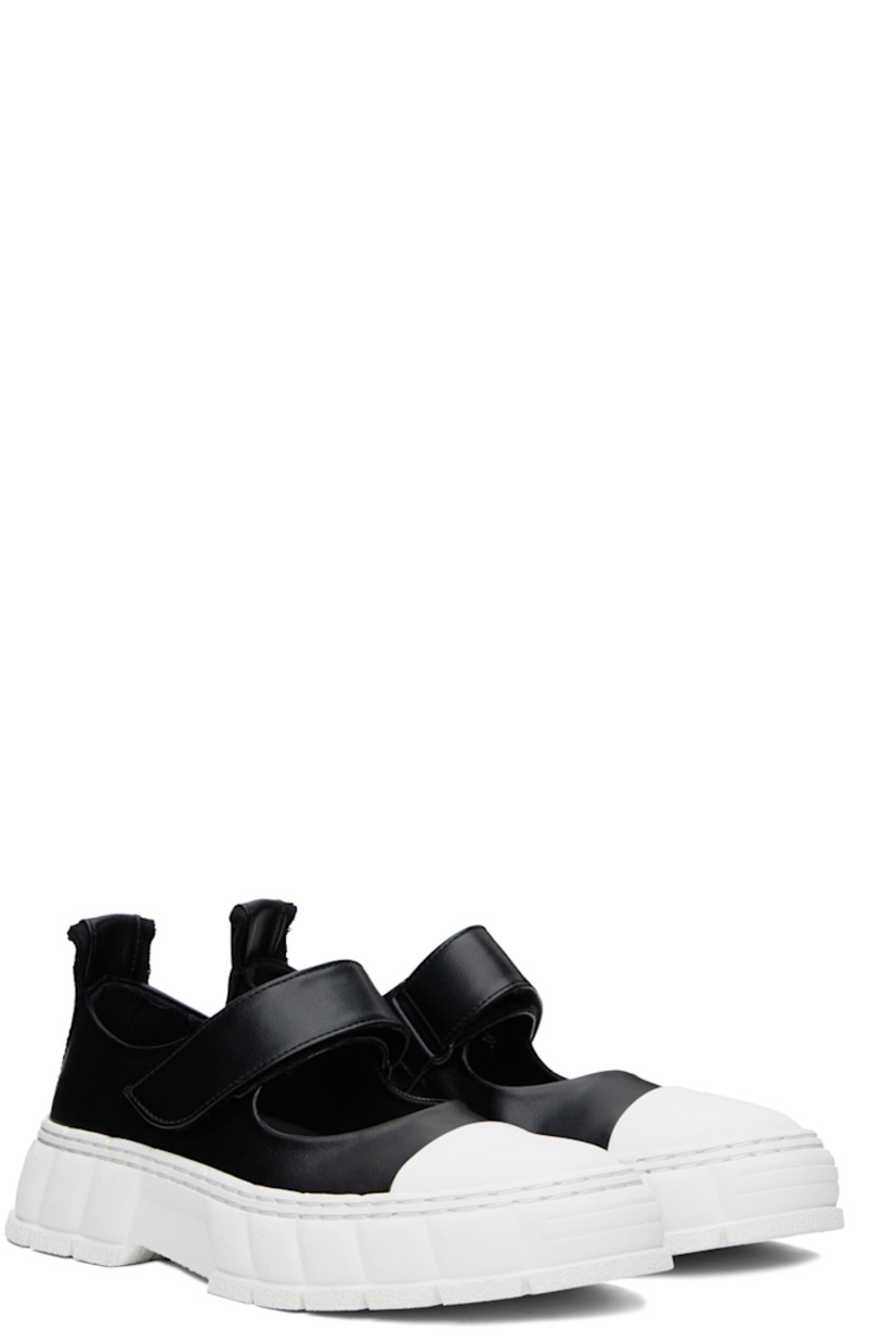 Handcrafted low-top PETA-certified buffed AppleSkin™️ faux-leather Mary Jane-style sneakers in black.

· Rubber cap toe
· Velcro strap at vamp
· Canvas trim and pull-loop at heel tab
· Logo embossed at heel counter
· Logo printed at padded footbed 
· Grained faux-leather lining
· Textured rubber platform midsole
· Treaded recycled rubber sole

Supplier color: Black apple