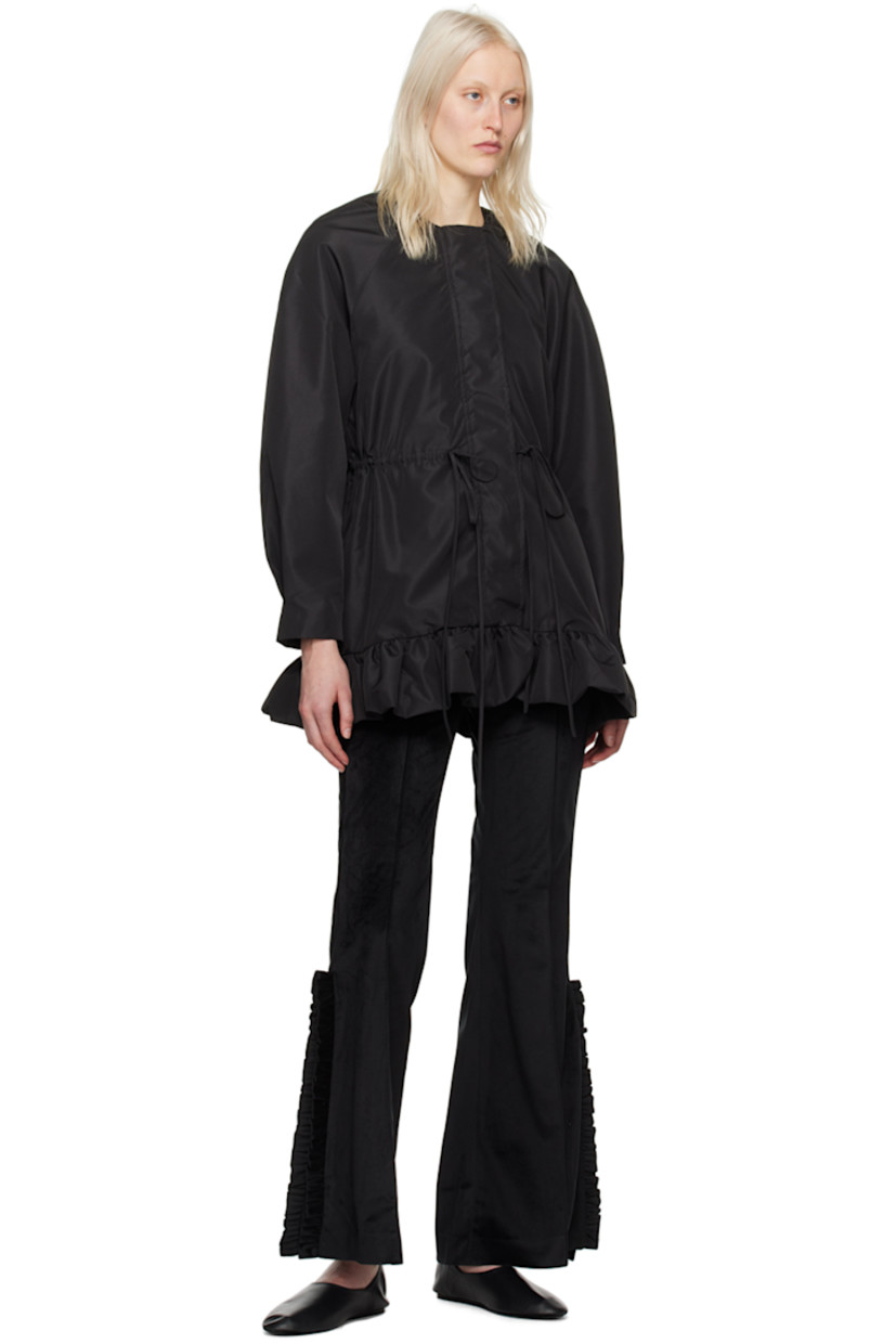 Polyester velveteen trousers. 

· Belt loops
· Four-pocket styling
· Zip-fly
· Pinched seam at legs
· Ruffled trim at vented at outseams

Supplier color: Black