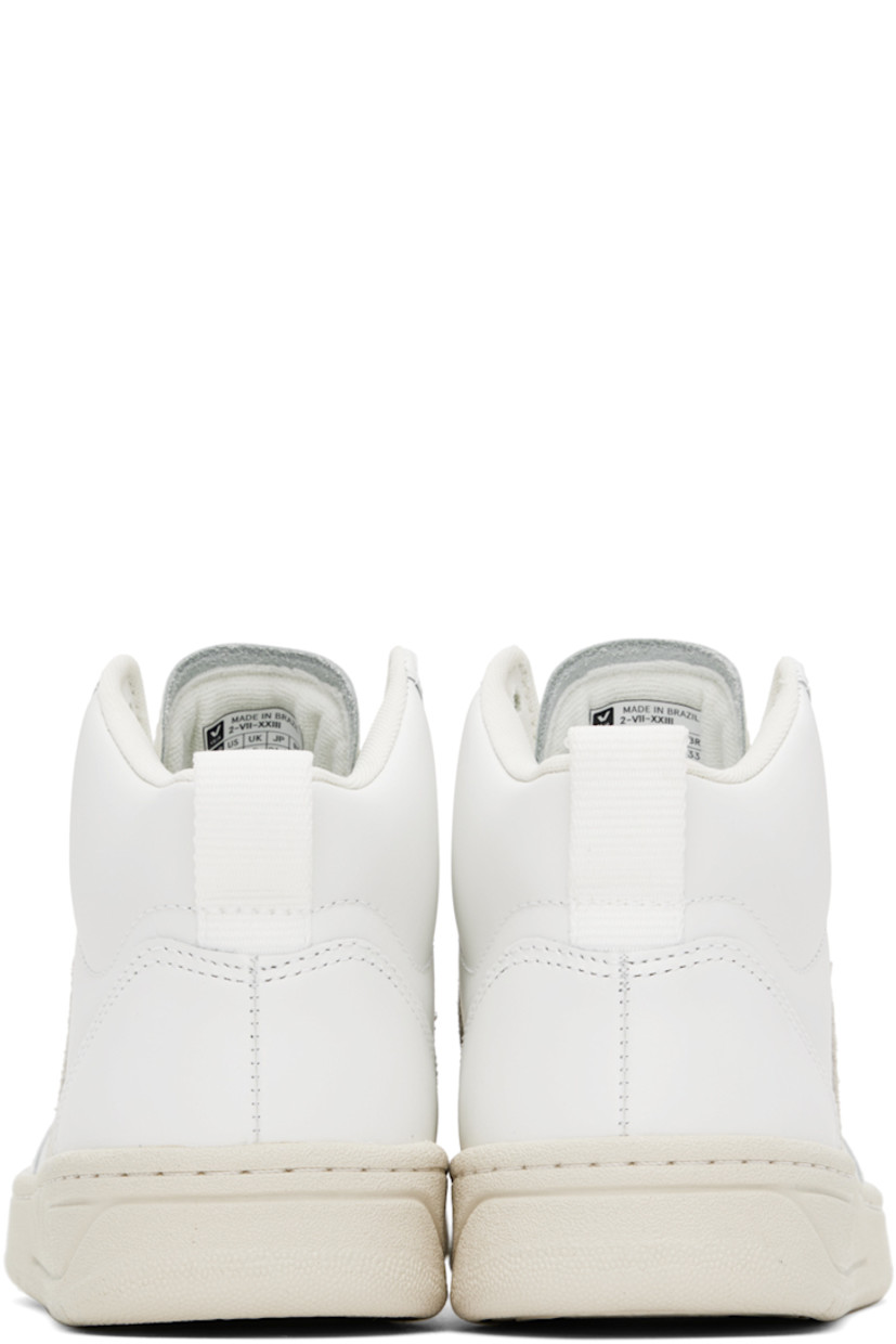High-top buffed leather sneakers in white. 

· Perforated detailing at toe
· Lace-up closure
· Logo embossed at tongue
· Padded collar
· Webbing pull-loop at heel collar
· Suede logo appliqué at sides
· Mesh lining
· Treaded rubber sole

Supplier color: Extra white/Natural