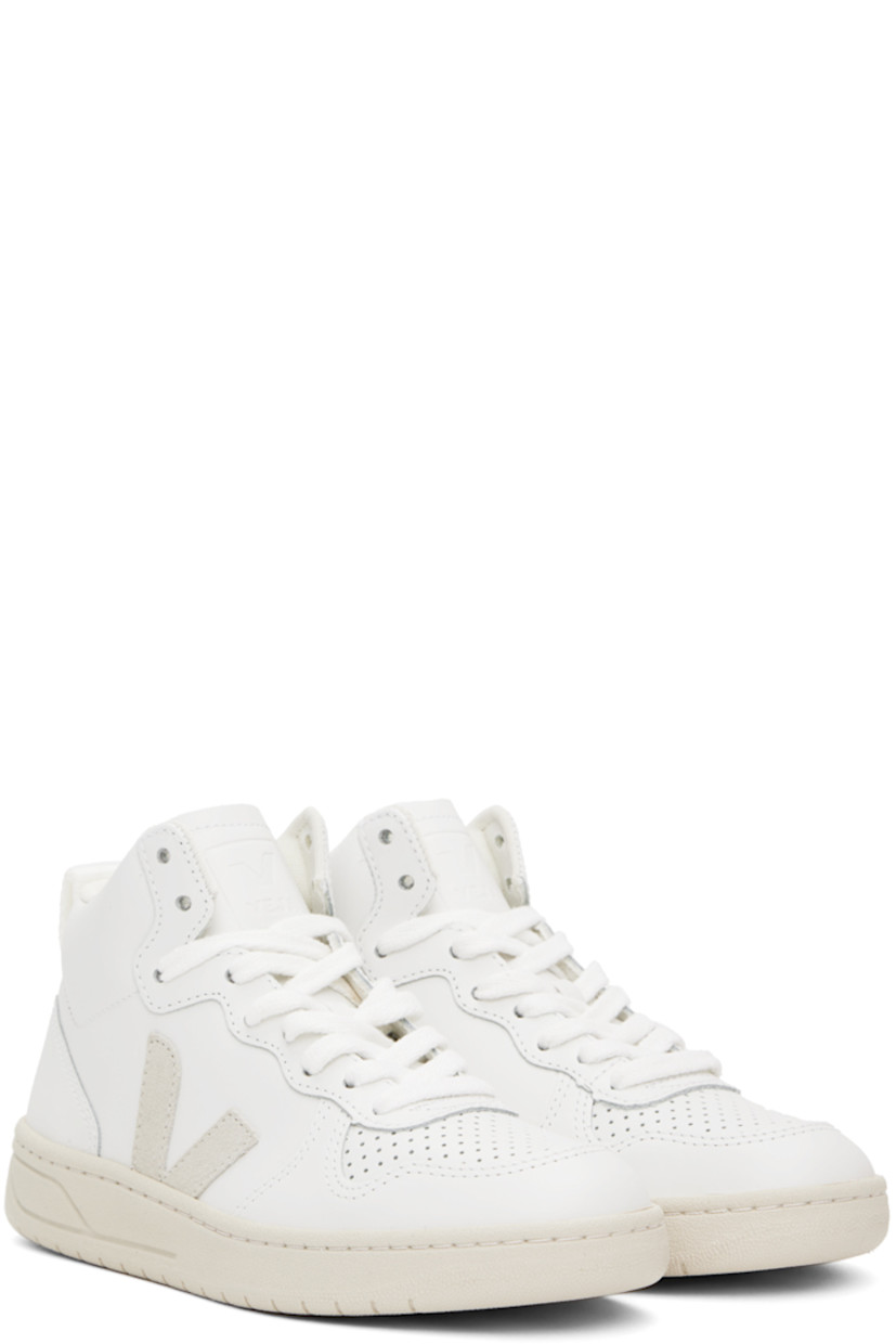 High-top buffed leather sneakers in white. 

· Perforated detailing at toe
· Lace-up closure
· Logo embossed at tongue
· Padded collar
· Webbing pull-loop at heel collar
· Suede logo appliqué at sides
· Mesh lining
· Treaded rubber sole

Supplier color: Extra white/Natural