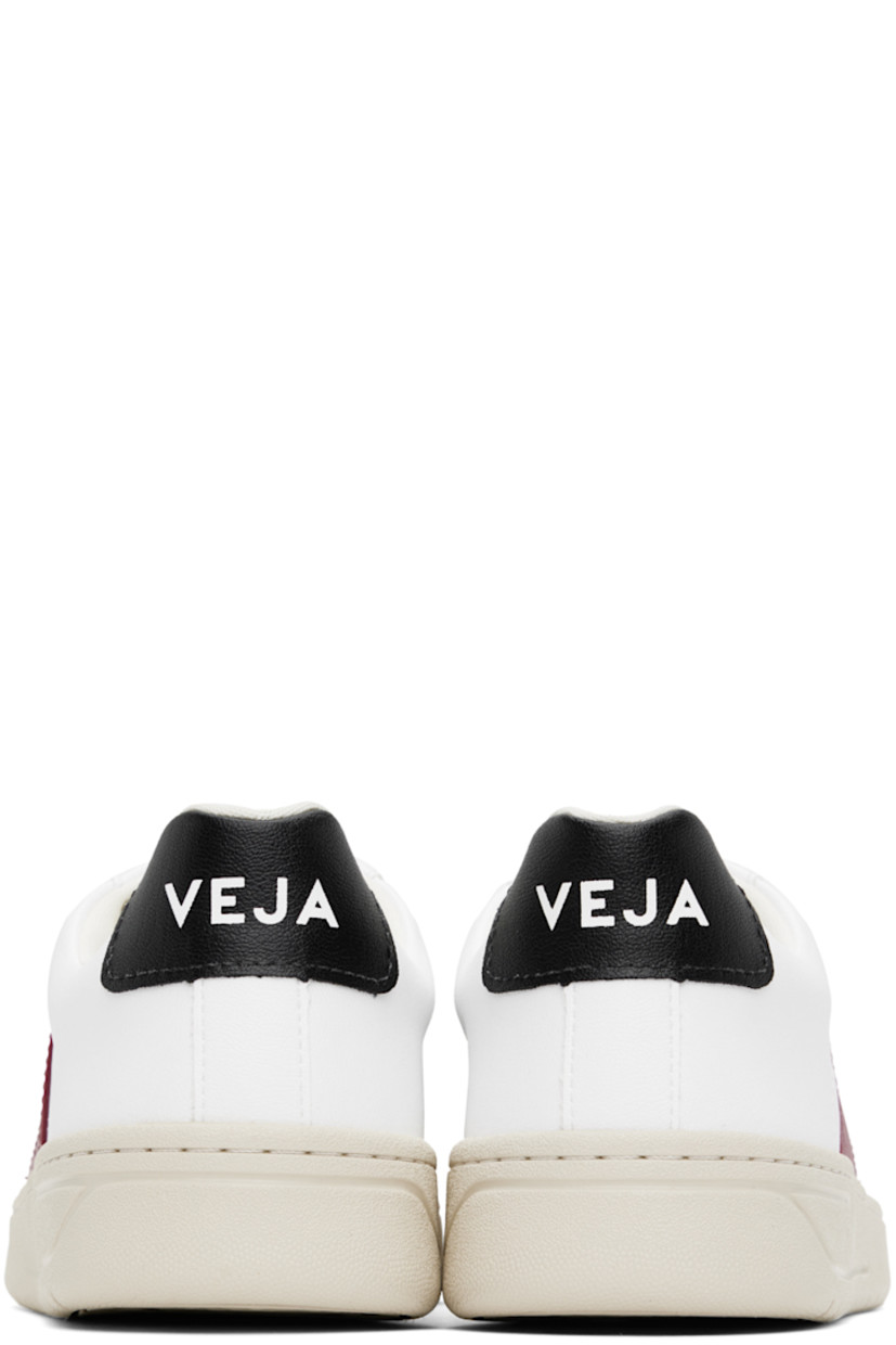 Low-top C.W.L. coated organic cotton faux-leather sneakers in white.

· Lace-up closure
· Padded tongue and collar
· Logo printed at tongue and heel tab
· Rubber logo appliqué at sides
· Recycled polyester jersey lining
· Treaded rubber sole

Supplier color: White/Marsala/Black