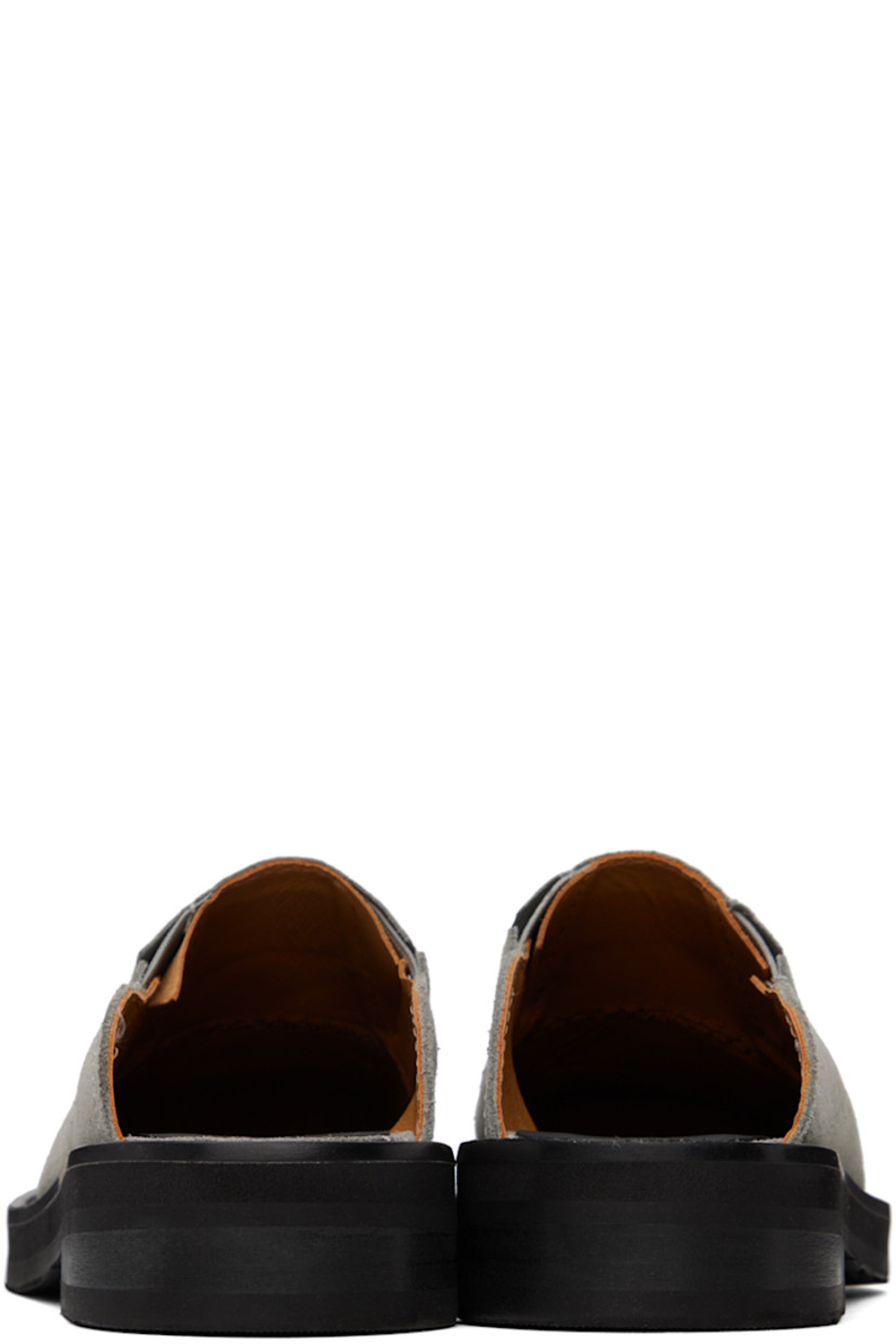 Suede mules in gray.

· Square toe
· Logo embossed at vamp
· Concealed elasticized gusset at sides
· Logo embossed at padded leather footbed
· Grained leather lining
· Topstitching at welt 
· Stacked leather heel with rubber injection
· Treaded rubber sole
· Heel: H1.25"

Supplier color: Grey