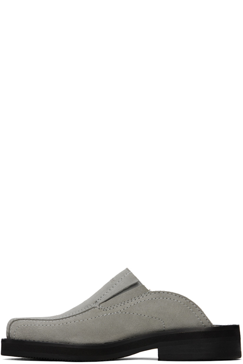 Suede mules in gray.

· Square toe
· Logo embossed at vamp
· Concealed elasticized gusset at sides
· Logo embossed at padded leather footbed
· Grained leather lining
· Topstitching at welt 
· Stacked leather heel with rubber injection
· Treaded rubber sole
· Heel: H1.25"

Supplier color: Grey