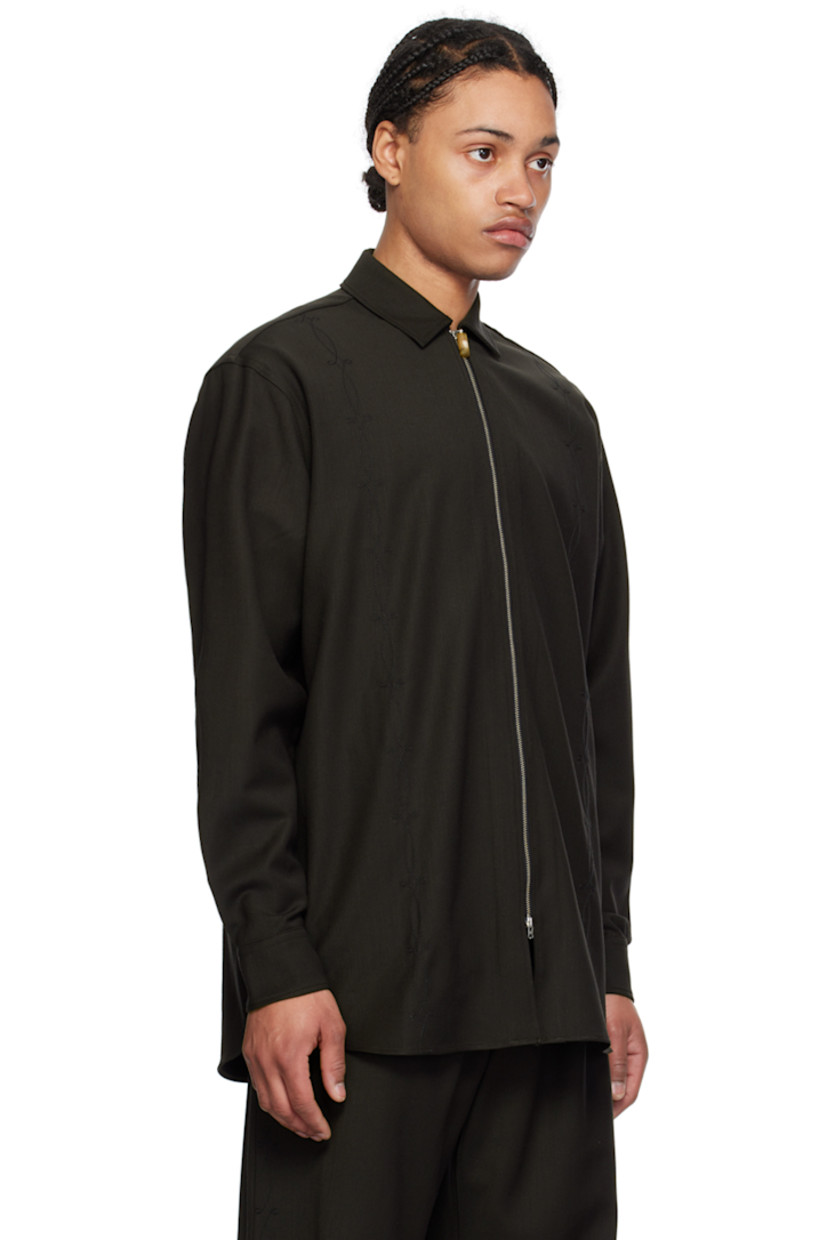 Stretch polyester- and wool-blend twill shirt.

· Spread collar
· Two-way zip closure
· Graphic pattern embroidered at front
· Modified shirttail hem
· Two-button barrel cuffs
· Box pleat at back yoke

Supplier color: Brown embroidered