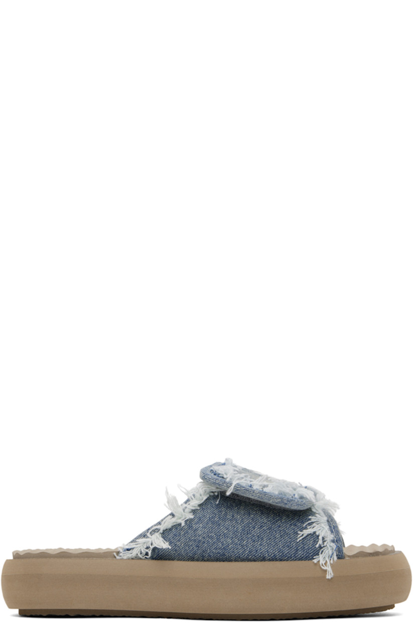 Denim slip-on sandals in blue.

· Fading and frayed edges throughout
· Open square toe
· Velcro strap at vamp
· Logo hardware at vamp
· Rubberized logo patch at foam footbed
· Terrycloth lining
· Treaded EVA foam platform sole
· Platform: H1.5"

Supplier color: Denim light stone