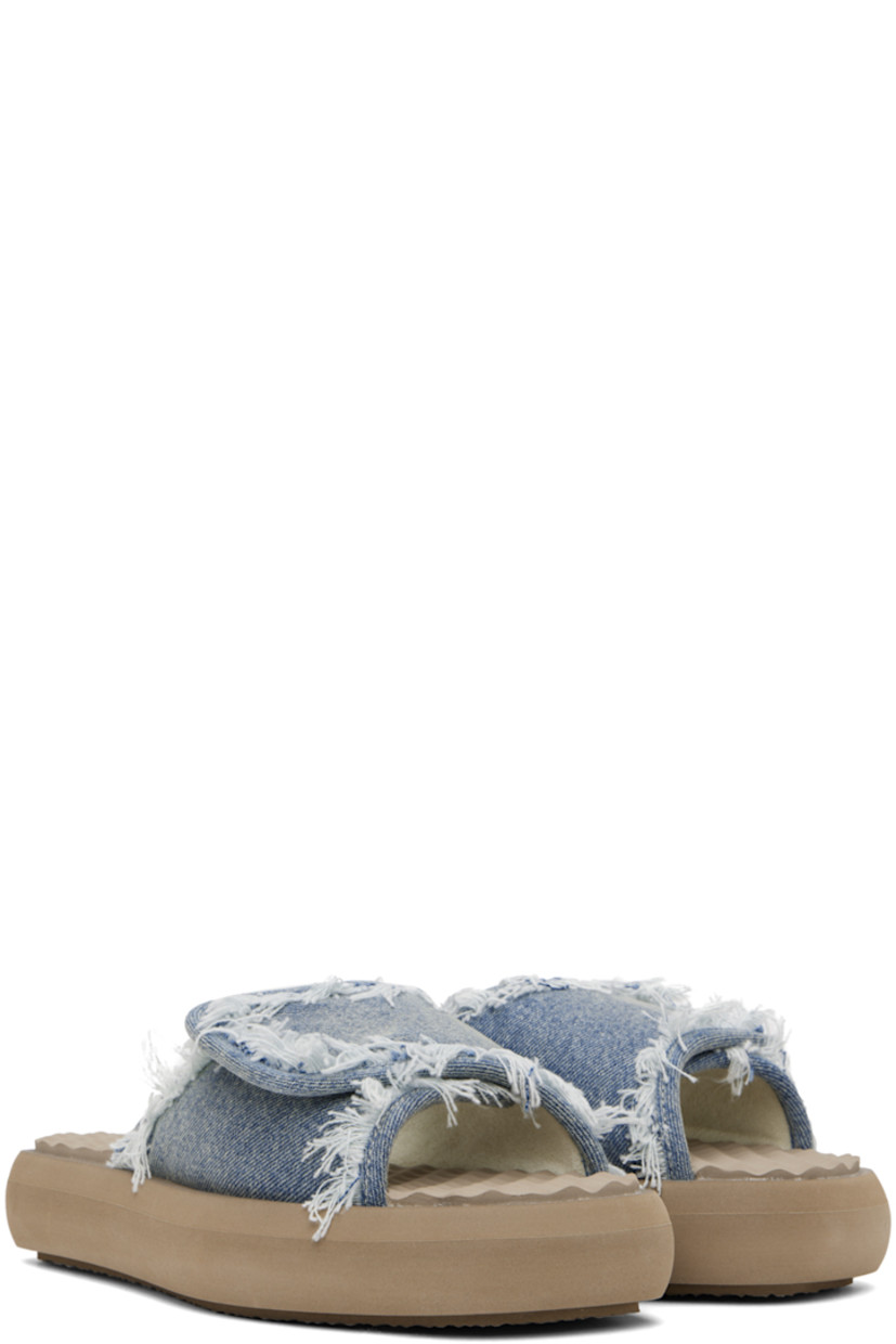 Denim slip-on sandals in blue.

· Fading and frayed edges throughout
· Open square toe
· Velcro strap at vamp
· Logo hardware at vamp
· Rubberized logo patch at foam footbed
· Terrycloth lining
· Treaded EVA foam platform sole
· Platform: H1.5"

Supplier color: Denim light stone