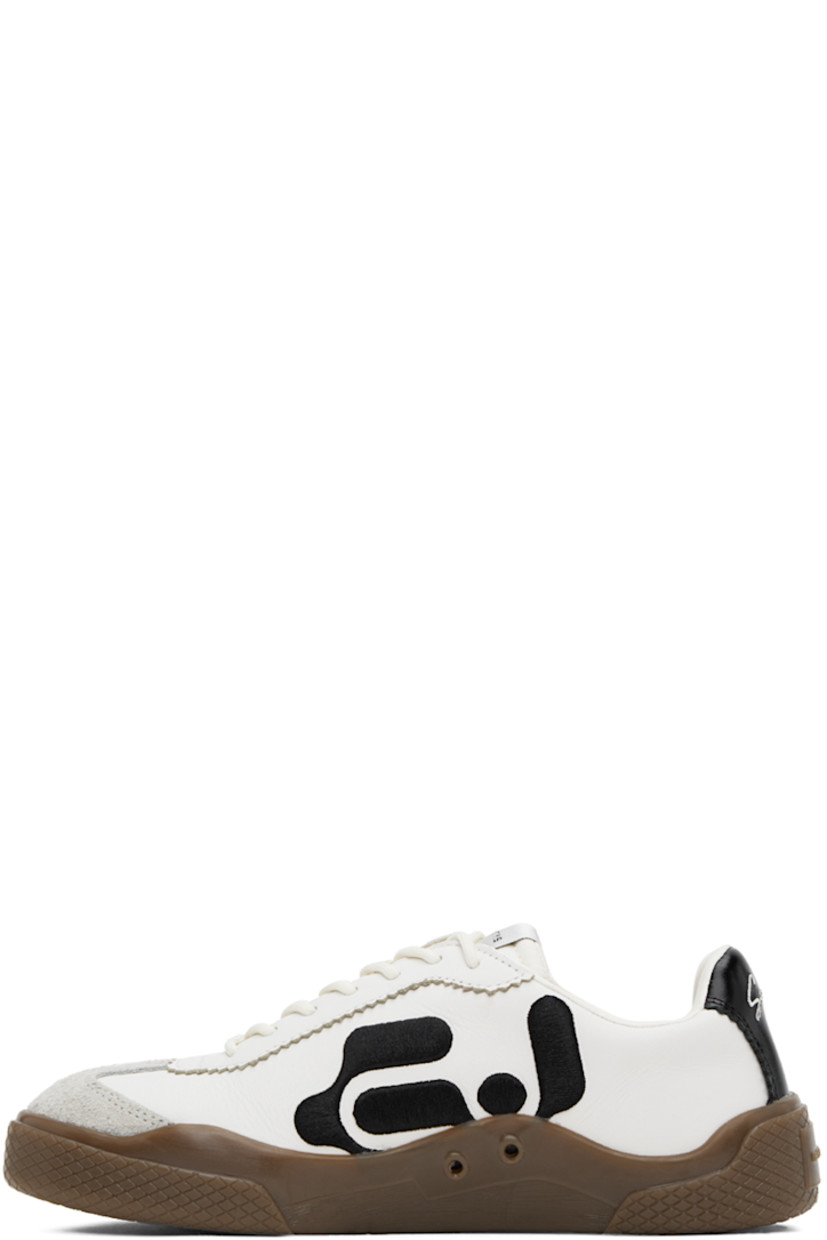 Low-top nappa leather sneakers in white. 

· Serrated edges throughout
· Suede cap toe
· Lace-up closure
· Logo patch at padded tongue
· Padded collar
· Logo embroidered at sides
· Eyelets at inner side
· Text embroidered at heel tab
· Logo embossed at heel
· Treaded rubber sole

Supplier color: Swan