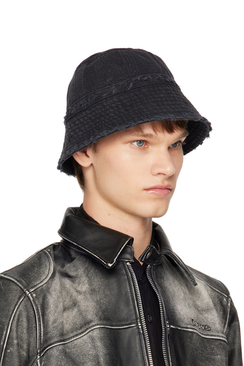 Non-stretch denim bucket hat in black.

· Fading and distressing throughout
· Logo plaque at face
· Quilted brim
· Poplin lining

Supplier color: Stone black