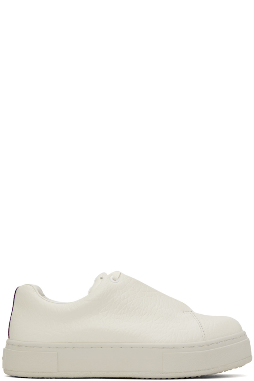 Low-top grained leather sneakers in off-white. 

· Lace-up closure
· Logo patch at padded tongue
· Padded collar
· Eyelets at inner side
· Webbing trim at heel
· Buffed leather lining
· Rubber platform midsole
· Treaded rubber sole

Supplier color: Tumbled white