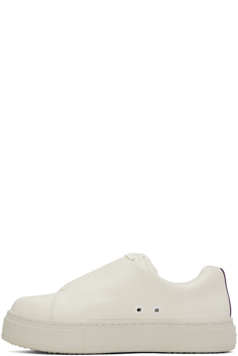 Low-top grained leather sneakers in off-white. 

· Lace-up closure
· Logo patch at padded tongue
· Padded collar
· Eyelets at inner side
· Webbing trim at heel
· Buffed leather lining
· Rubber platform midsole
· Treaded rubber sole

Supplier color: Tumbled white
