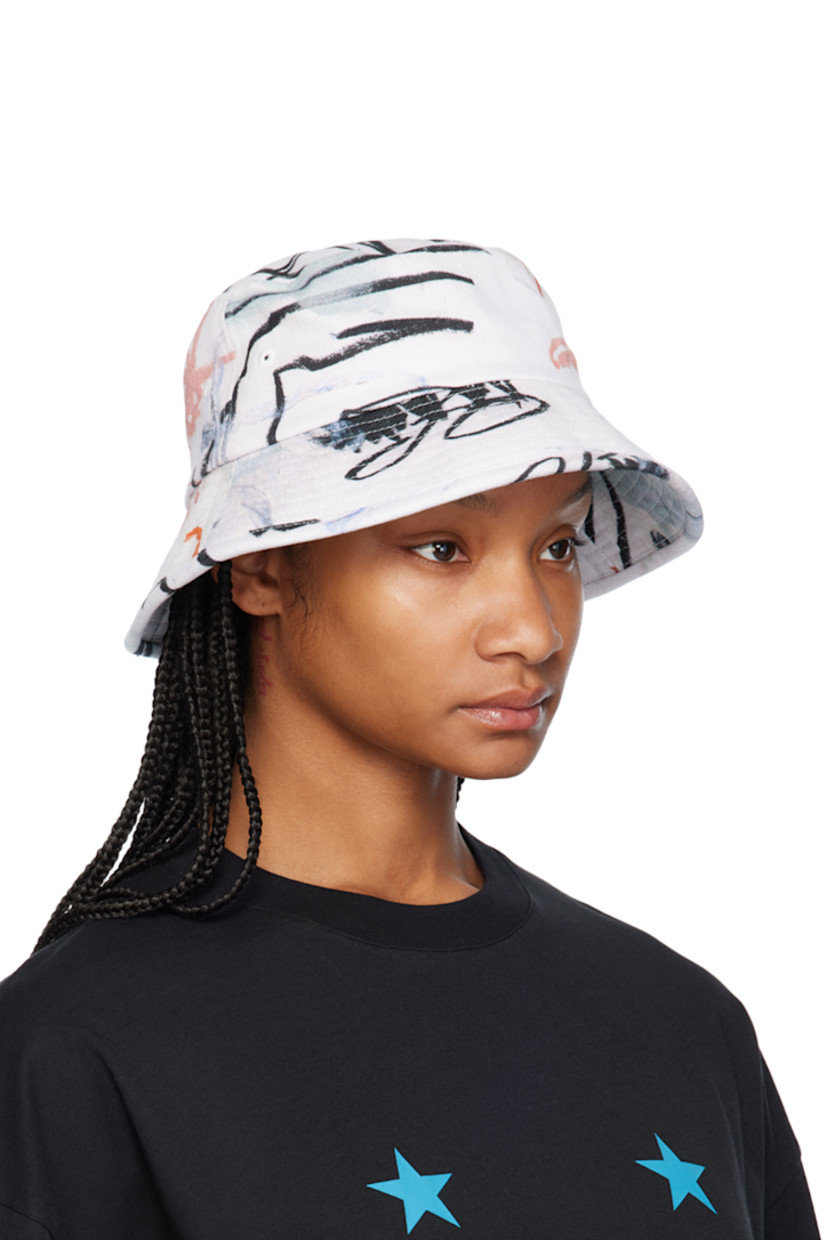 Cotton twill bucket hat in white. 

· Graphic printed throughout
· Eyelets at crown
· Logo hardware at face
· Quilted brim
· Canvas lining

Featuring artwork by Julian Farade.

Supplier color: Ciel de mai