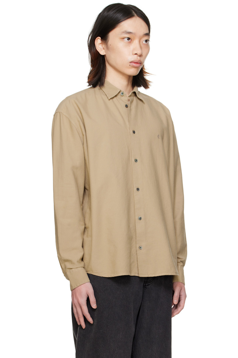 Cotton broadcloth shirt.

· Spread collar
· Button closure
· Logo embroidered at chest
· Shirttail hem
· Single-button barrel cuffs
· Mother-of-pearl hardware

Supplier color: Sand