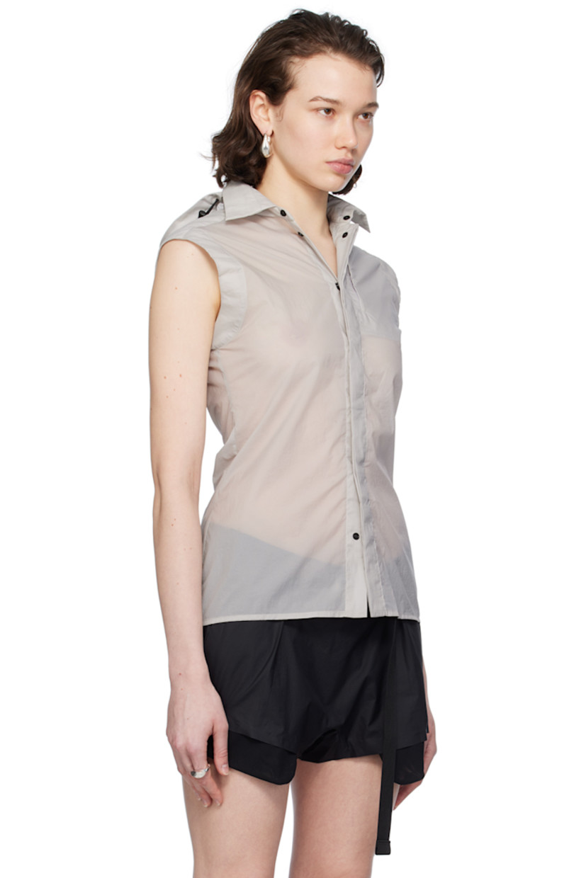 Semi-sheer recycled nylon ripstop vest. 

· Bungee-style drawstring at detachable hood
· Spread collar
· Concealed press-stud closure
· Zip pocket at chest
· Shirttail hem
· Zip vent at back

Supplier color: Light grey
