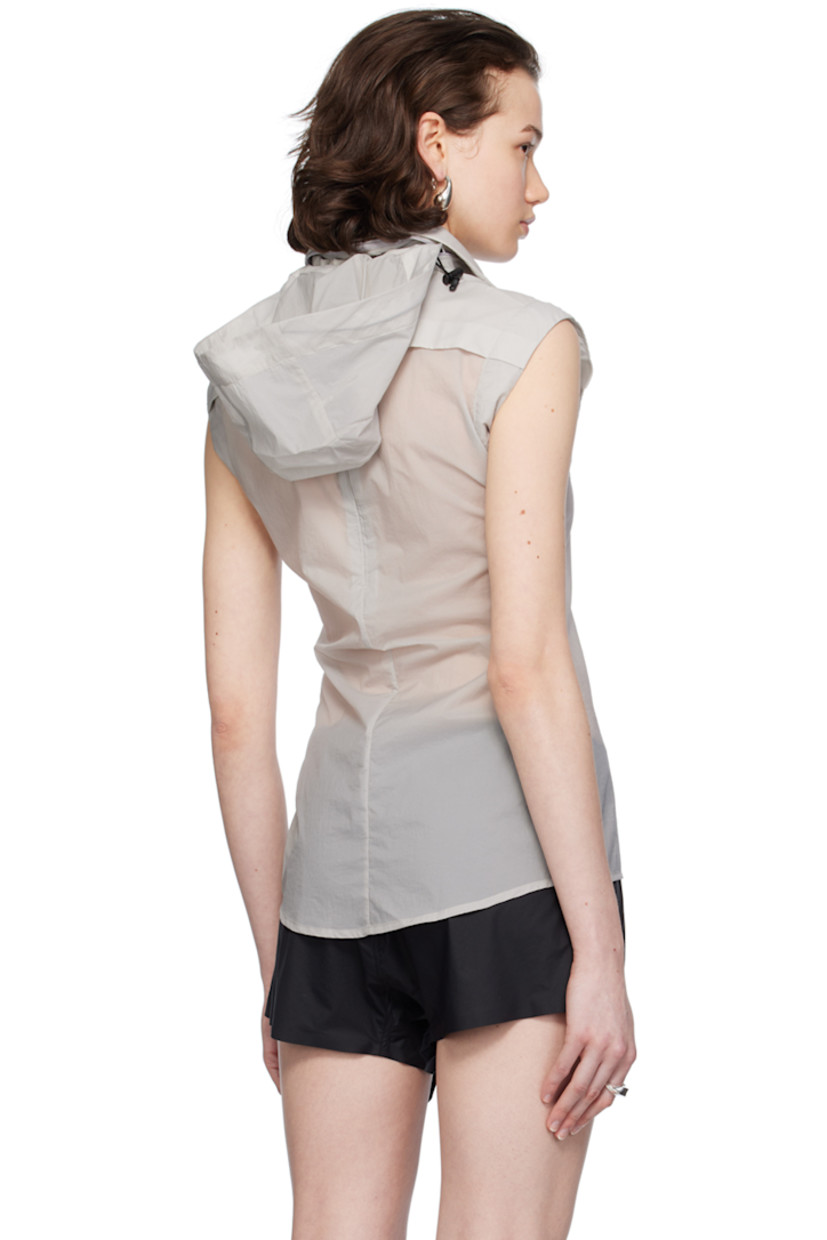 Semi-sheer recycled nylon ripstop vest. 

· Bungee-style drawstring at detachable hood
· Spread collar
· Concealed press-stud closure
· Zip pocket at chest
· Shirttail hem
· Zip vent at back

Supplier color: Light grey