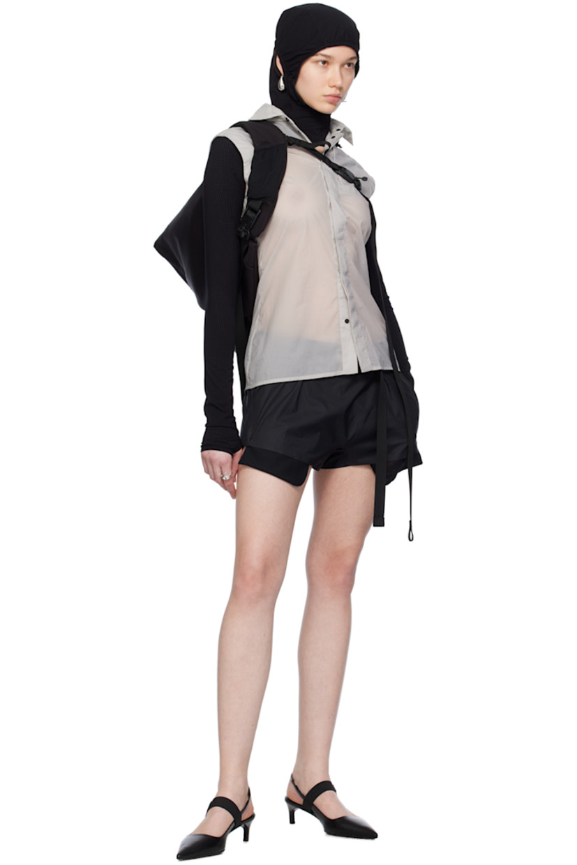 Semi-sheer recycled nylon ripstop vest. 

· Bungee-style drawstring at detachable hood
· Spread collar
· Concealed press-stud closure
· Zip pocket at chest
· Shirttail hem
· Zip vent at back

Supplier color: Light grey