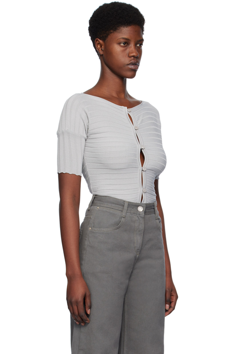 Rib knit rayon-blend cardigan. Rolled edges throughout.

· Boat neck
· Button closure
· Scalloped edge at cuffs
 
Supplier color: Silver