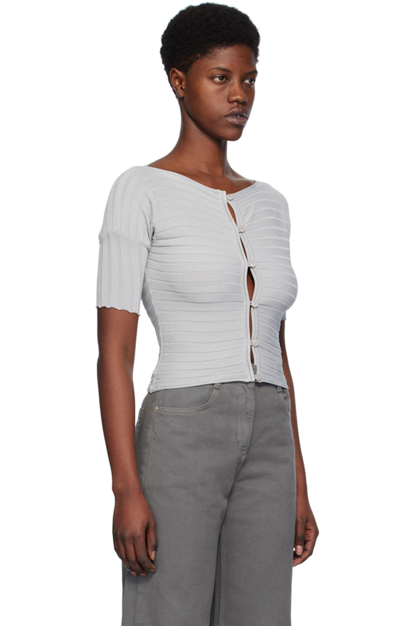Rib knit rayon-blend cardigan. Rolled edges throughout.

· Boat neck
· Button closure
· Scalloped edge at cuffs
 
Supplier color: Silver