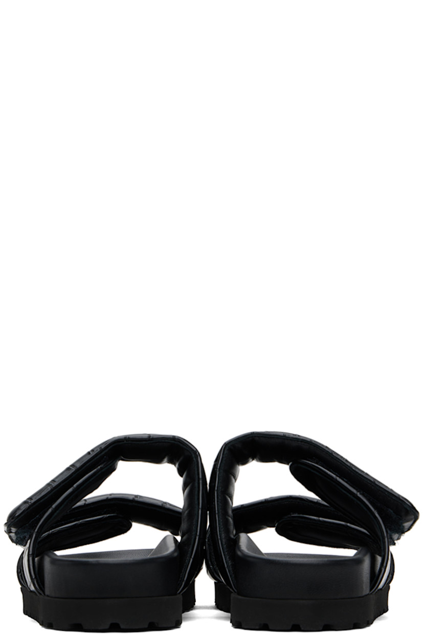 Croc-embossed faux-leather flat sandals in black.

· Open toe
· Padded velcro straps at vamp
· Logo embossed at molded footbed
· Foam rubber midsole
· Treaded rubber sole

Supplier color: Black