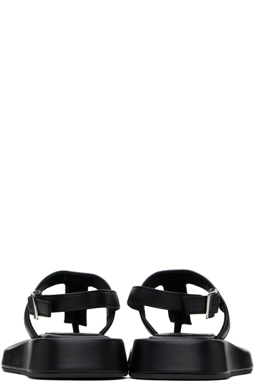 Grained leather flat sandals in black.

· Open square toe
· Thong-style strap at vamp
· Pin-buckle ankle strap
· Logo embossed at padded footbed
· Covered midsole
· Rubber sole

Supplier color: Black