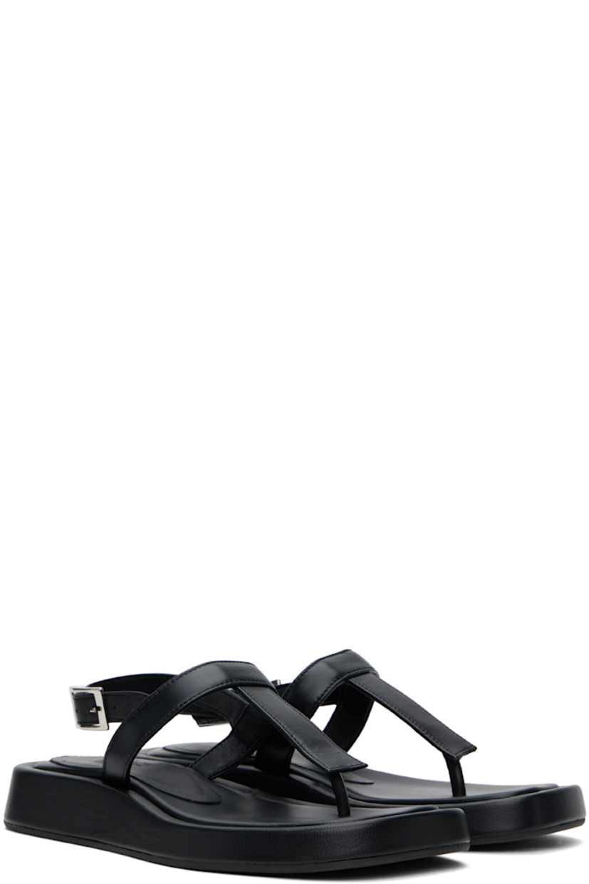 Grained leather flat sandals in black.

· Open square toe
· Thong-style strap at vamp
· Pin-buckle ankle strap
· Logo embossed at padded footbed
· Covered midsole
· Rubber sole

Supplier color: Black