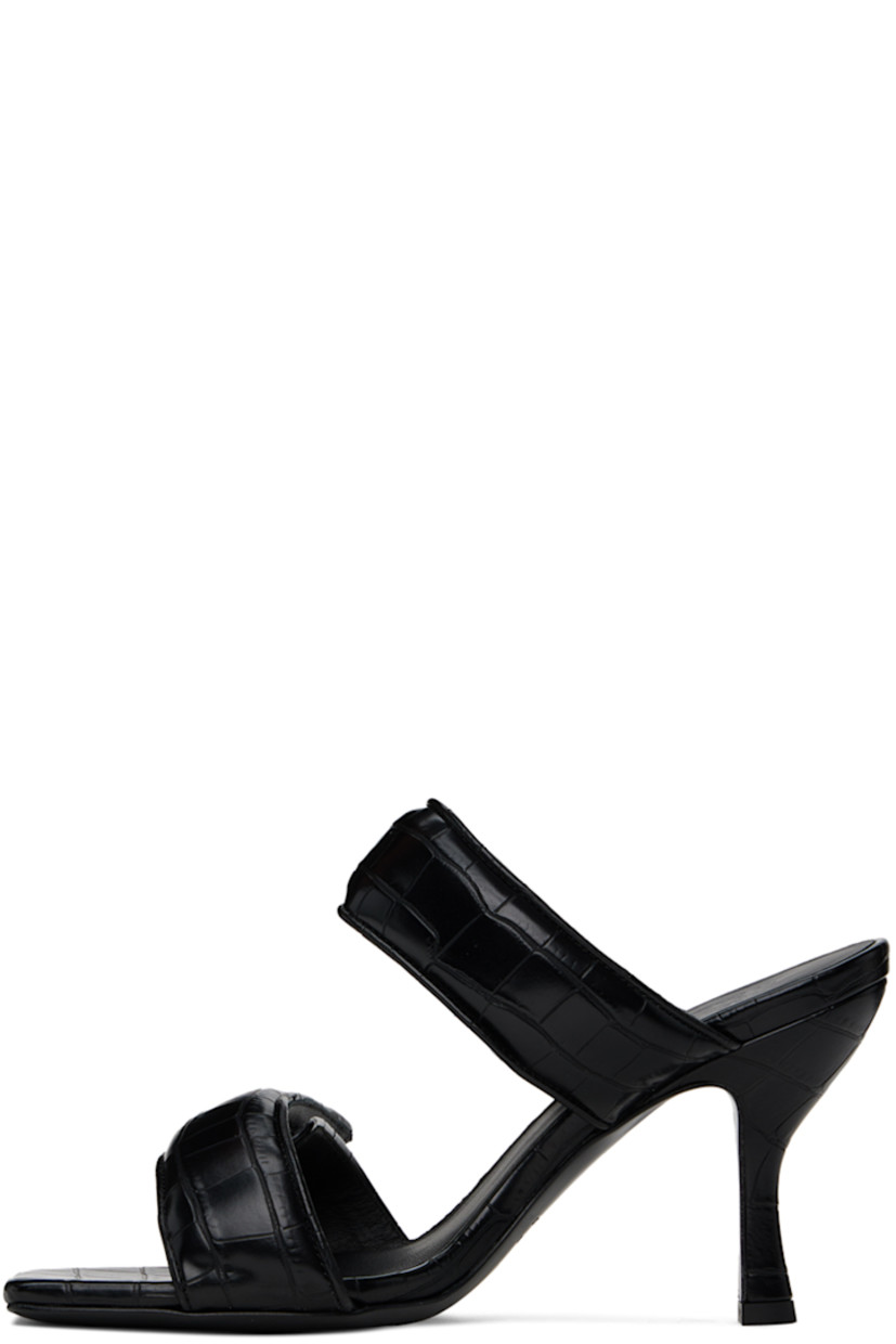 Croc-embossed faux-leather slip-on heeled sandals in black.

· Open square toe
· Padded velcro straps at vamp
· Logo embossed at footbed
· Covered stiletto heel with rubber injection
· Leather sole
· Heel: H3.75"

Supplier color: Black