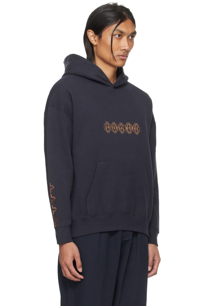 Cotton fleece hoodie.

· Logo printed at front
· Kangaroo pocket
· Rib knit hem and cuffs
· Graphic embroidered at sleeve
· Logo and text printed at back

Supplier color: Navy