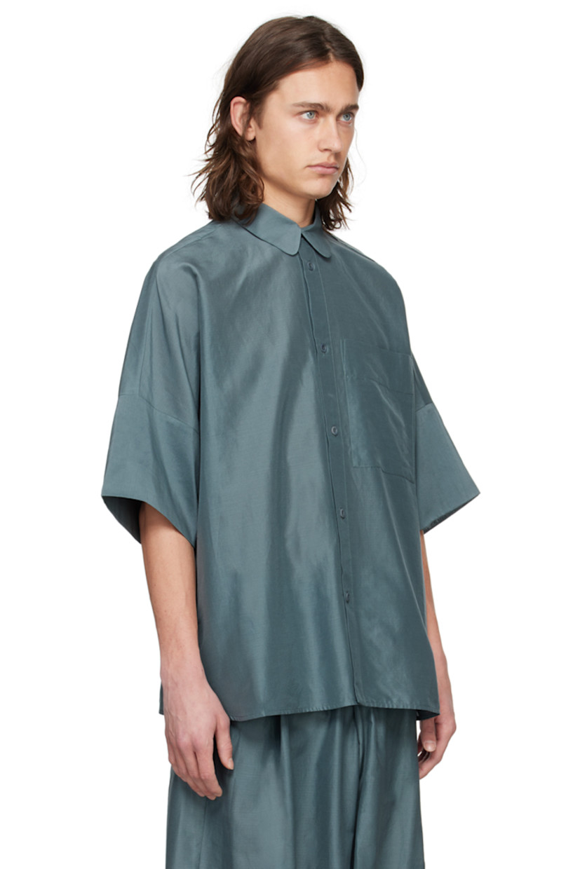 Lightweight plain-woven cotton- and silk-blend shirt. 

· Spread collar
· Button closure
· Patch pocket
· Shirttail hem
· Dropped shoulders
· Inverted box pleat at back yoke 

Supplier color: Lead