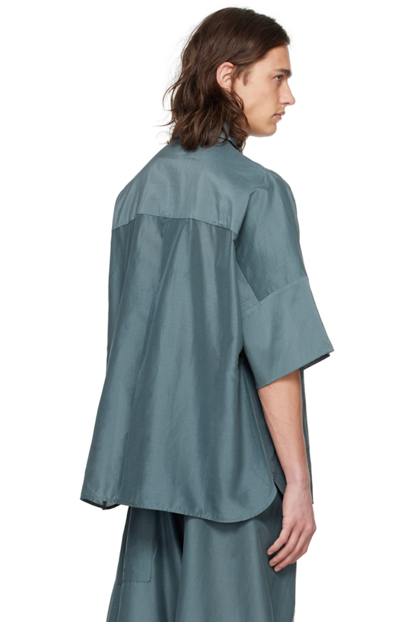 Lightweight plain-woven cotton- and silk-blend shirt. 

· Spread collar
· Button closure
· Patch pocket
· Shirttail hem
· Dropped shoulders
· Inverted box pleat at back yoke 

Supplier color: Lead