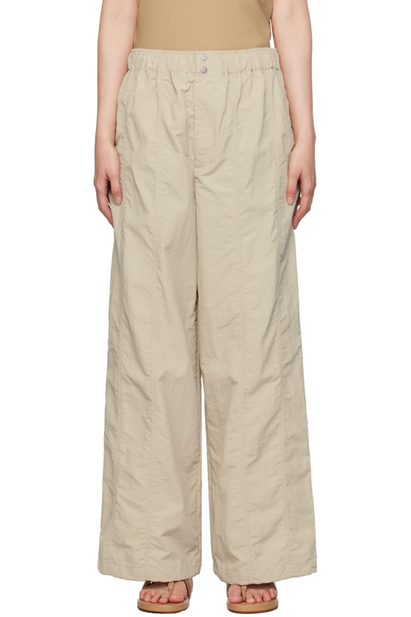 Nylon taffeta trousers.

· Elasticized waistband
· Four-pocket styling
· Zip-fly
· Concealed bungee-style drawstring at cuffs

Supplier color: Stone