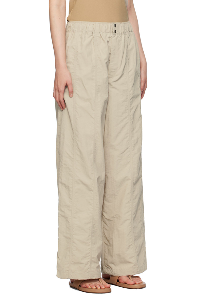 Nylon taffeta trousers.

· Elasticized waistband
· Four-pocket styling
· Zip-fly
· Concealed bungee-style drawstring at cuffs

Supplier color: Stone