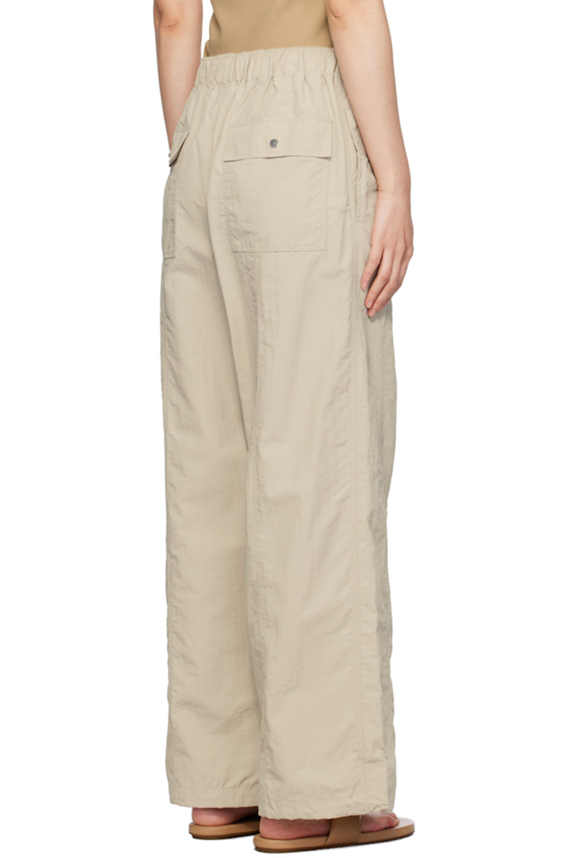 Nylon taffeta trousers.

· Elasticized waistband
· Four-pocket styling
· Zip-fly
· Concealed bungee-style drawstring at cuffs

Supplier color: Stone